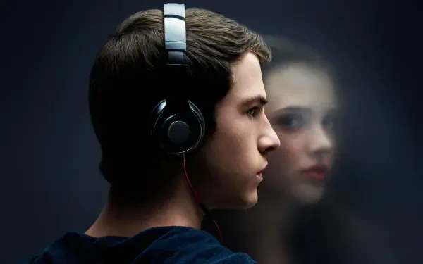 HD PC desktop wallpaper featuring a close-up of a young man wearing headphones with a blurred reflection of a girl in the background, inspired by 13 Reasons Why.
