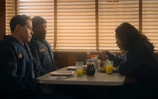 HD PC desktop wallpaper from the movie The Pickup, showing three people sitting at a diner booth with blinds casting warm light inside.