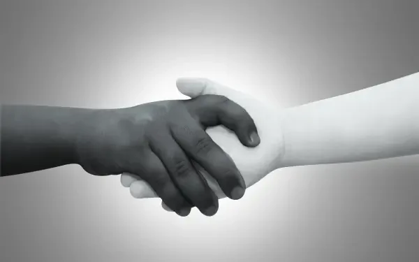 HD PC desktop wallpaper of two children's hands—one dark, one light—shaking in a simple handshake symbolizing peace and love.