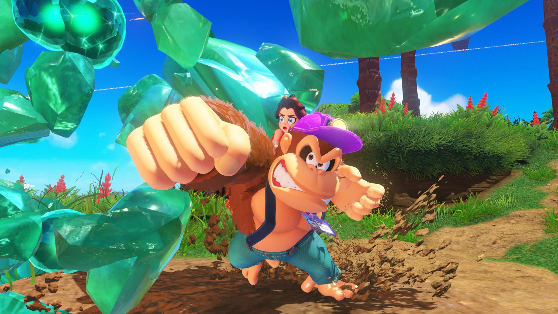 Donkey Kong Bananza HD PC desktop wallpaper and background: Donkey Kong lunges across a grassy, crystal-strewn island with a small companion perched on his shoulder.