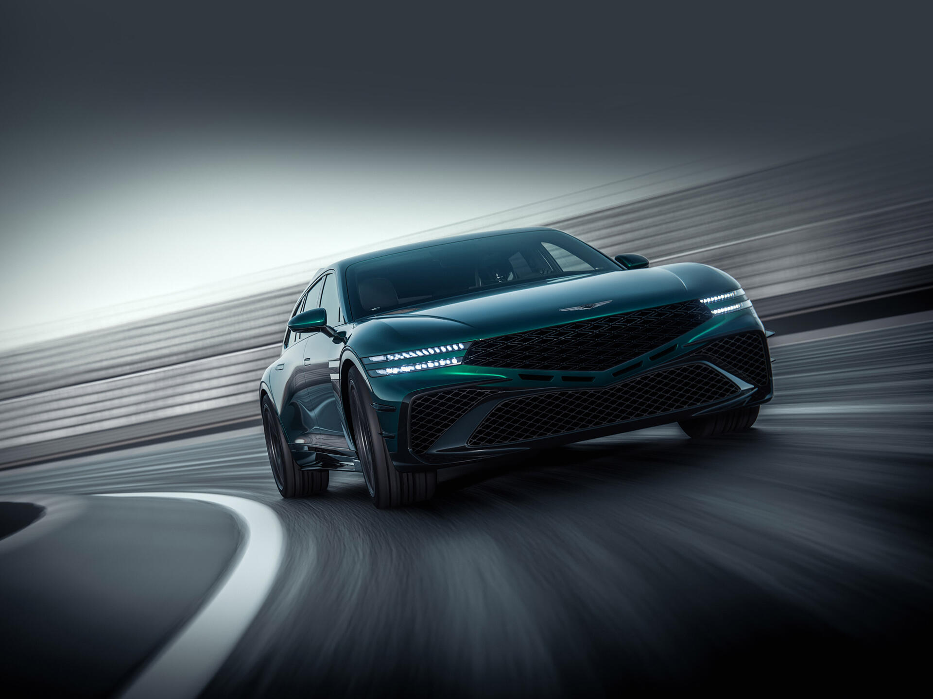 Green Genesis G90 sedan speeding through a curved track with motion blur — 2K Quad HD PC desktop wallpaper