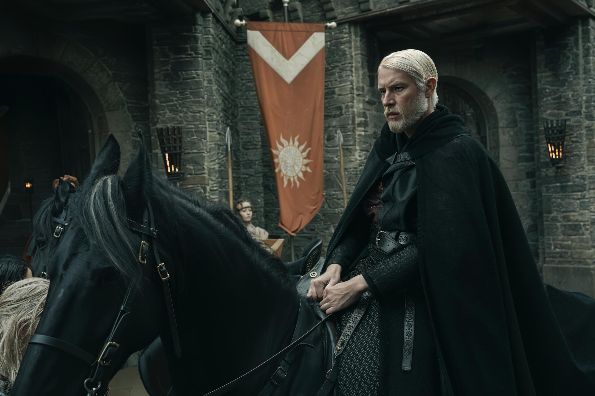 Cloaked knight astride a black horse in a dim stone hall beneath a sunburst banner — cinematic 4K Ultra HD PC desktop wallpaper from the TV show A Knight of the Seven Kingdoms.