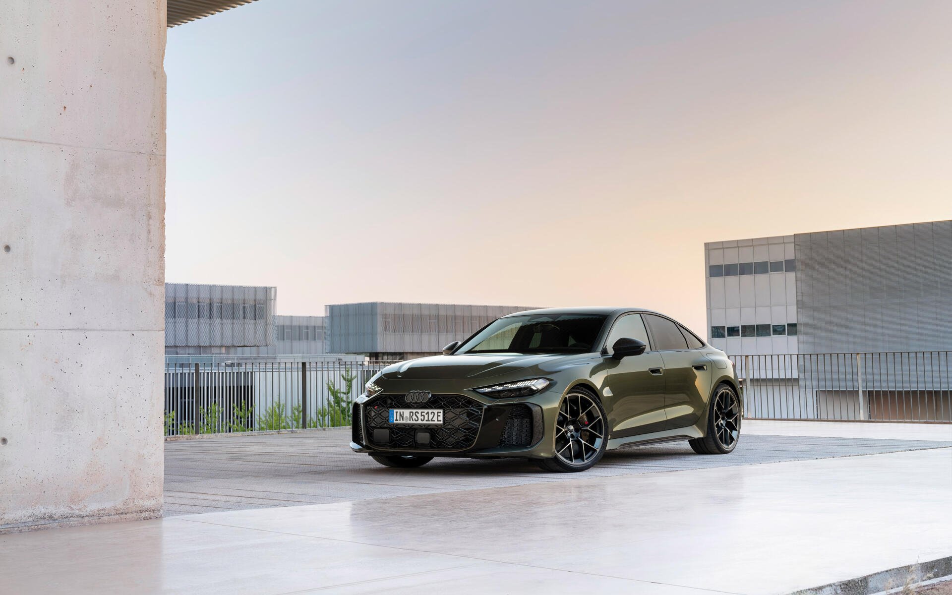 Dark Audi RS5 vehicle parked in a minimalist concrete urban setting, presented as a 2K Quad HD PC desktop wallpaper/background.