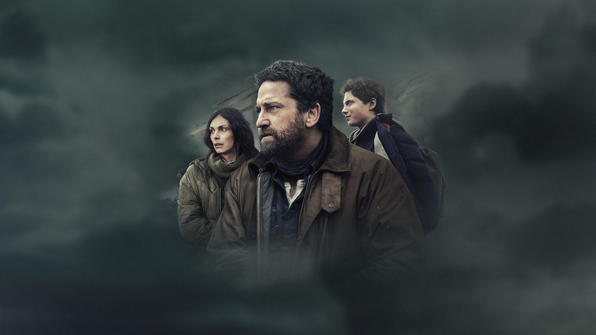 Greenland 2: Migration — three people emerge from dark, stormy mist with tense expressions; cinematic 4K Ultra HD PC desktop wallpaper and background.