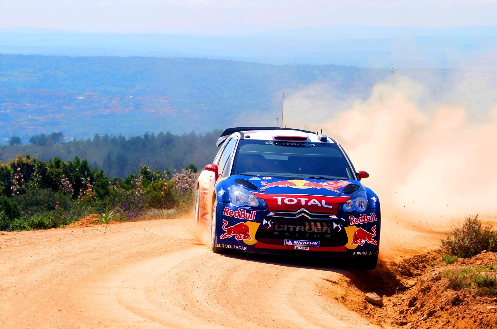 2K Quad HD PC desktop background: Citroën DS3 WRC race car tearing down a dusty dirt stage, WRC livery and sponsor logos visible.