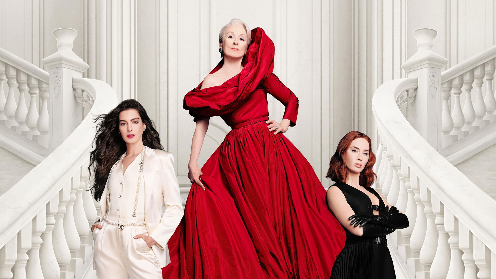 The Devil Wears Prada 2 — 2K Quad HD PC desktop wallpaper: three elegant women on a sweeping white staircase; center in a voluminous red gown, flanked by figures in white and black.