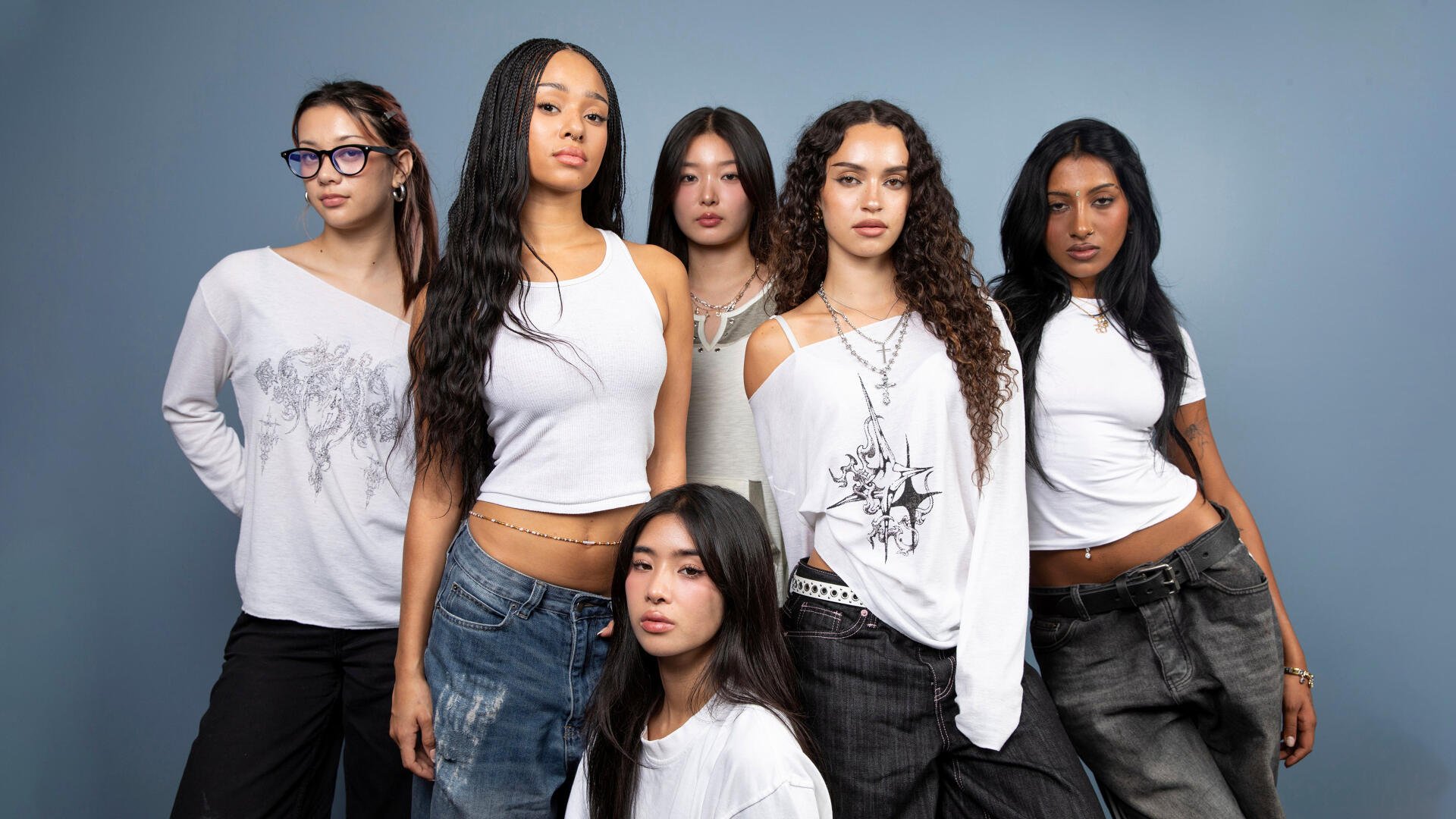 Katseye pop music girl band of six posing against a gray backdrop in white tops and dark pants — 4K Ultra HD PC desktop wallpaper/background.