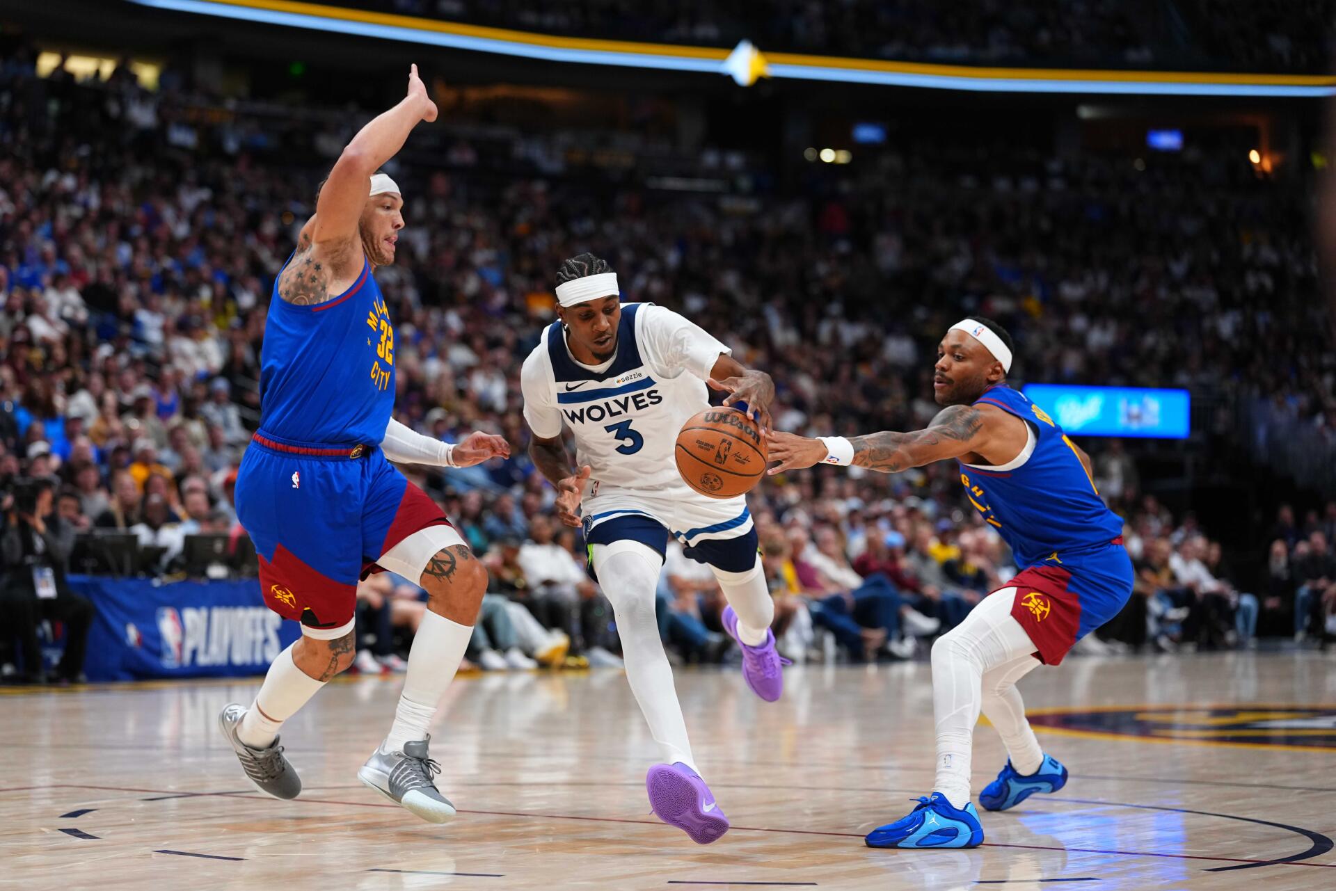 8K Ultra HD NBA basketball PC desktop wallpaper: Minnesota Timberwolves player drives to the hoop between two defenders in a packed arena.