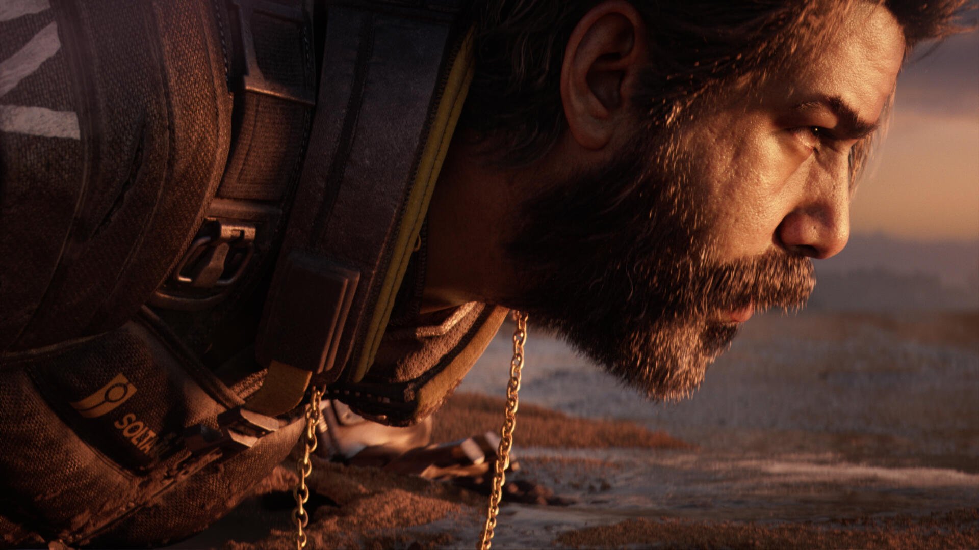 Close-up of a bearded video game character from Saros in 4K Ultra HD, gritty profile with tactical gear and warm desert light — PC desktop wallpaper and background.