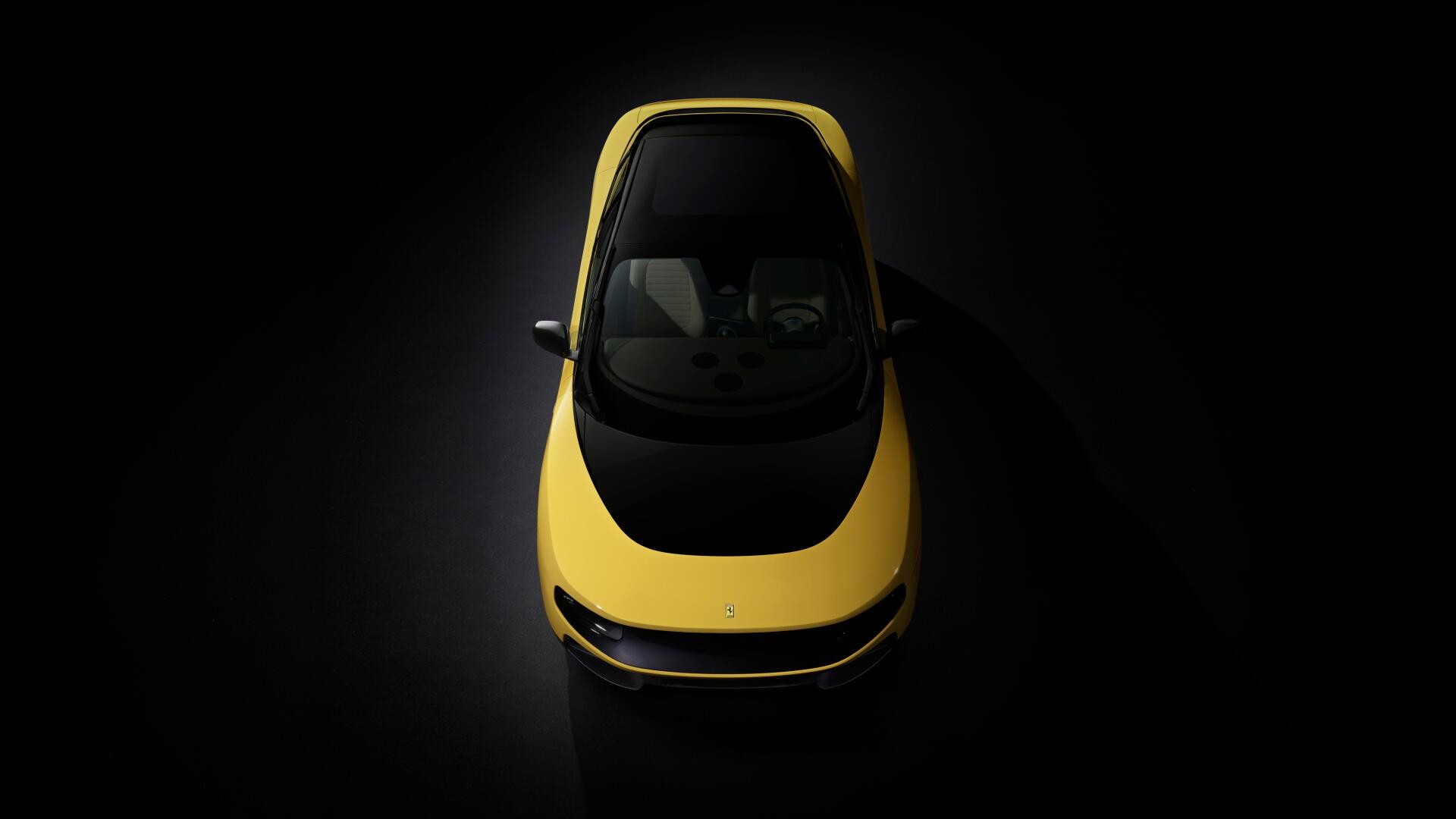 Top-down view of a yellow Ferrari Luce vehicle on a dark backdrop, 4K Ultra HD PC desktop wallpaper and background.