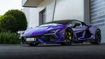 Purple Lamborghini Reventón luxury car parked by a modern building — 5K Ultra HD PC desktop wallpaper/background.