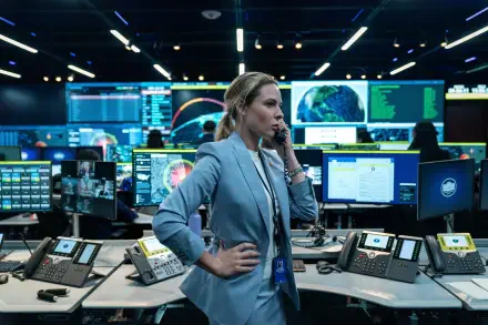Cinematic 4K desktop wallpaper: a woman in a busy command center speaking on a headset, framed as a still from the movie A House of Dynamite.