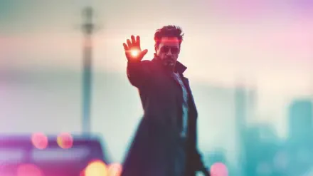 4K Ultra HD PC wallpaper of superhero Tony Stark/Iron Man extending his hand, firing a red laser beam into a blurred urban skyline background.
