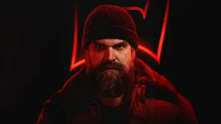 Stranger Things 4K Ultra HD PC desktop wallpaper: bearded man in knit cap and coat, lit by red neon '5' emblem against a dark background.