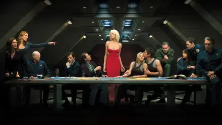 Battlestar Galactica (2003) scene: dim war-room with crew around a long table; a woman in a red dress stands center. 2K Quad HD PC desktop wallpaper and background.