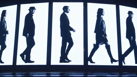 Now You See Me 2 4K Ultra HD PC desktop wallpaper: black-and-white silhouettes of four people walking across illuminated vertical panels.