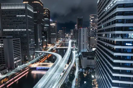 4K Ultra HD PC desktop wallpaper of Osaka, Japan — a nightscape of illuminated highways threading between high-rise buildings, with streaking light trails and glowing city lights.
