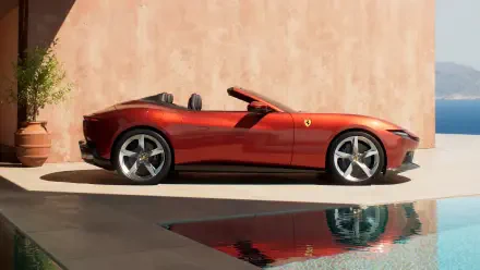 Red Ferrari Amalfi Spider convertible parked by a pool with sea view and reflection, shown as a 4K Ultra HD PC desktop wallpaper and background.