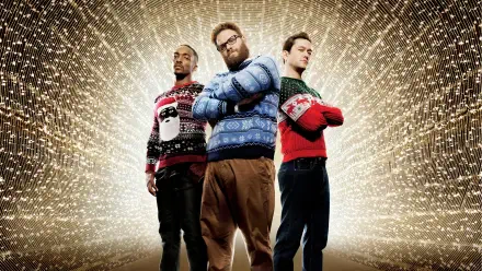 Three men in festive holiday sweaters stand with arms crossed before a radiant golden spark burst — 4K Ultra HD PC Desktop Wallpaper and Background.