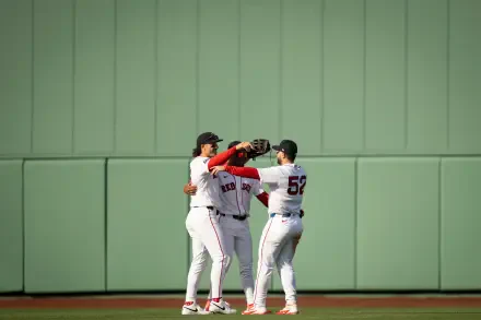 Four Boston Red Sox players embrace on the outfield grass against a green wall — 4K Ultra HD PC desktop wallpaper background, MLB baseball sports image.
