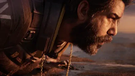 Close-up of a bearded video game character from Saros in 4K Ultra HD, gritty profile with tactical gear and warm desert light — PC desktop wallpaper and background.