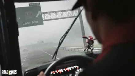 Road Kings video game: driver-view through rain-smeared windshield on a highway, dashboard figurine in foreground, 4K Ultra HD PC desktop wallpaper/background.