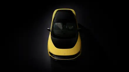 Top-down view of a yellow Ferrari Luce vehicle on a dark backdrop, 4K Ultra HD PC desktop wallpaper and background.