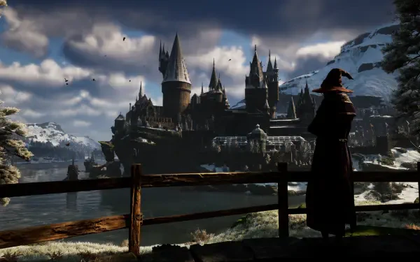 HD PC desktop wallpaper of Hogwarts Castle from the video game Hogwarts Legacy at dusk, a cloaked figure on a railing overlooks the snowy lakeside gaming environment.