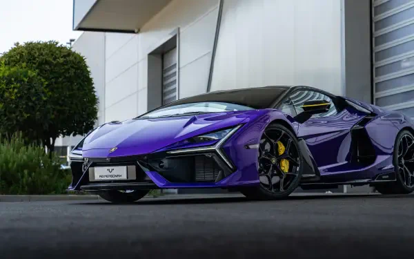 Purple Lamborghini Reventón luxury car parked by a modern building — 5K Ultra HD PC desktop wallpaper/background.