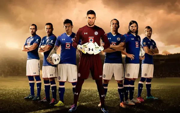HD desktop wallpaper of Cruz Azul soccer goalkeeper in maroon, holding a ball and standing with teammates in blue kits on a dramatic stadium background.