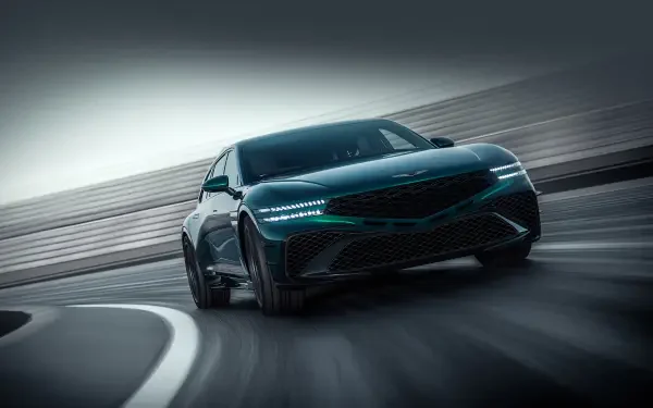 Green Genesis G90 sedan speeding through a curved track with motion blur — 2K Quad HD PC desktop wallpaper