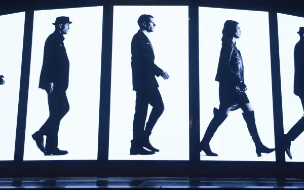 Now You See Me 2 4K Ultra HD PC desktop wallpaper: black-and-white silhouettes of four people walking across illuminated vertical panels.