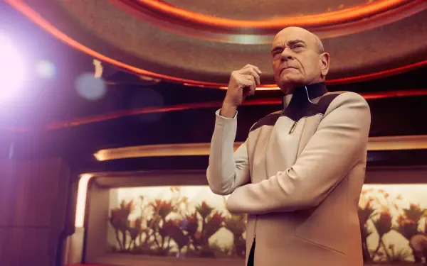 4K Ultra HD PC desktop wallpaper/background from the TV show Star Trek: Starfleet Academy: a stern, bald officer in a beige uniform stands with arms crossed on a starship bridge.