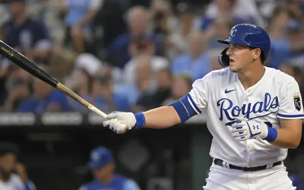 HD PC desktop wallpaper of a Kansas City Royals batter in white uniform swinging a bat with a blurred crowd behind him.