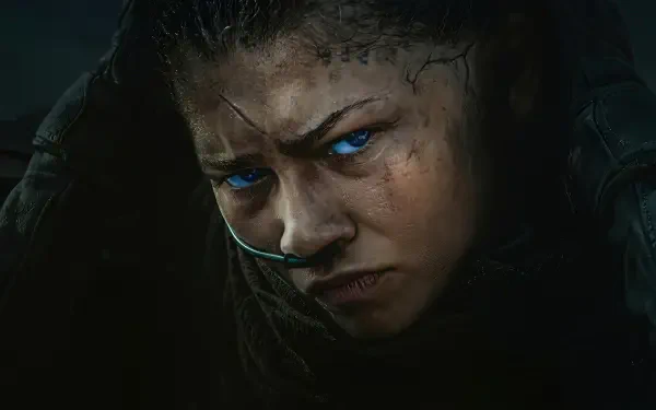 Dune: Part Three 4K Ultra HD PC desktop wallpaper — close-up of a sand-scarred fighter with respirator, intense glare and glowing blue eyes in dark, cinematic lighting.