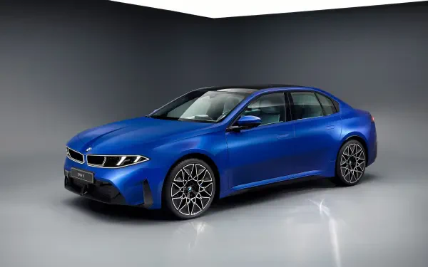 Blue BMW i3 electric vehicle photographed in a studio, shown centered on a glossy floor — 4K Ultra HD PC desktop wallpaper/background.