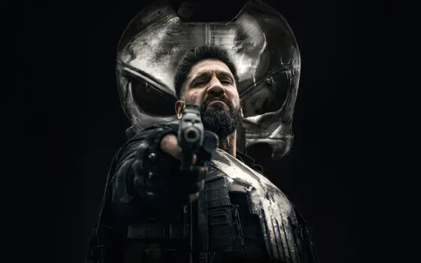 The Punisher: One Last Kill — brooding vigilante in tactical gear points a gun beneath a giant skull emblem, 4K Ultra HD PC desktop wallpaper and background.