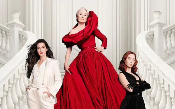 The Devil Wears Prada 2 — 2K Quad HD PC desktop wallpaper: three elegant women on a sweeping white staircase; center in a voluminous red gown, flanked by figures in white and black.