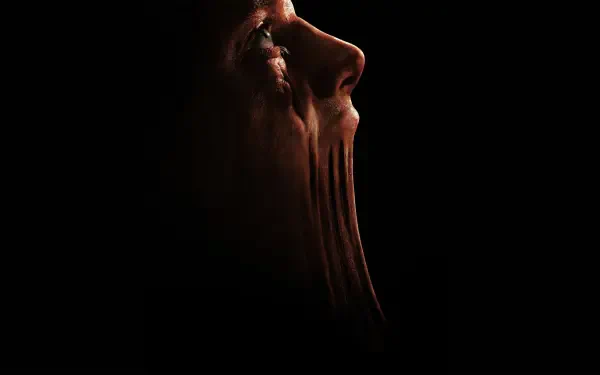 Clayface profile melting into shadow with stretched, clay-like texture — 4K Ultra HD PC desktop wallpaper and background.