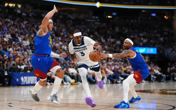8K Ultra HD NBA basketball PC desktop wallpaper: Minnesota Timberwolves player drives to the hoop between two defenders in a packed arena.