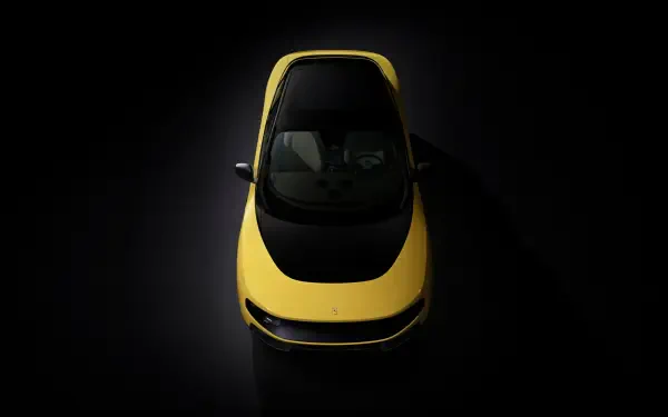 Top-down view of a yellow Ferrari Luce vehicle on a dark backdrop, 4K Ultra HD PC desktop wallpaper and background.