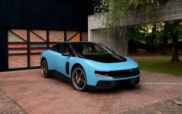 Light blue Ferrari Luce sports vehicle parked outside a modern garage, high-detail 4K Ultra HD PC desktop wallpaper/background.