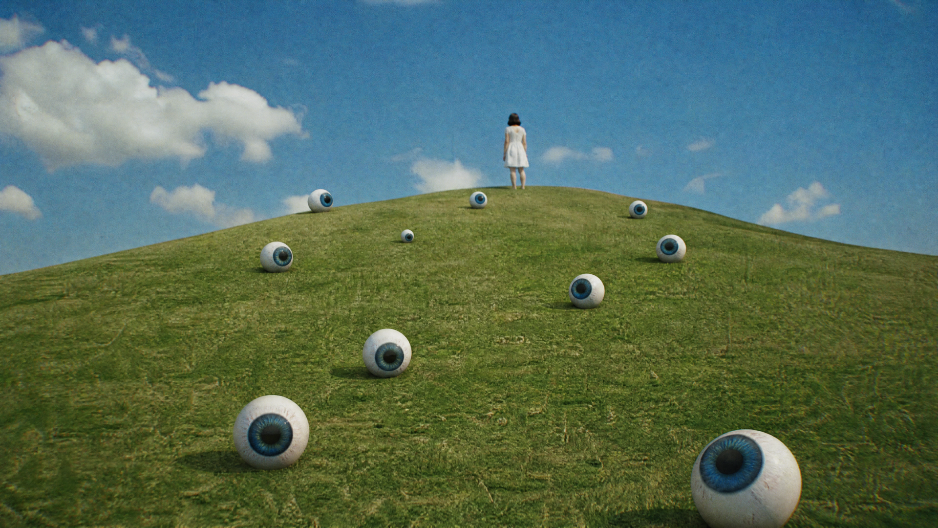 Weirdcore 4K Ultra HD PC desktop wallpaper/background: lone figure in white atop a grassy hill dotted with oversized eyeballs under a bright blue sky.
