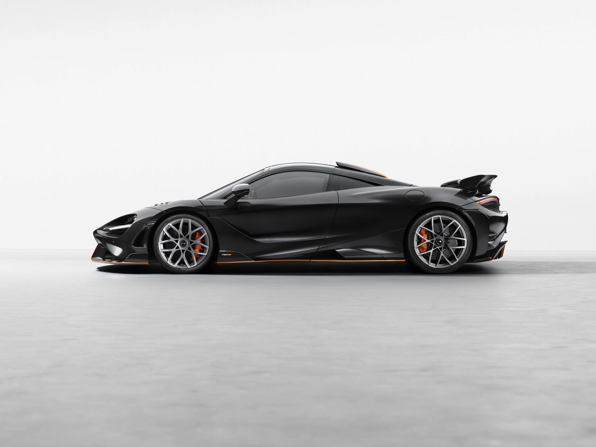 Side profile of a black McLaren 788HS sports car on a clean white backdrop, 8K Ultra HD PC desktop wallpaper and background.