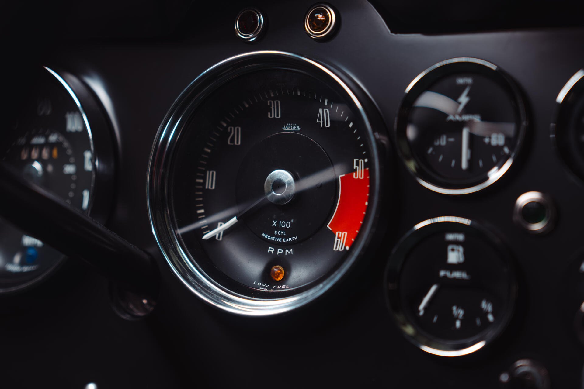 8K Ultra HD desktop wallpaper: close-up of McLaren G6GT dashboard, central tachometer and surrounding analog gauges.
