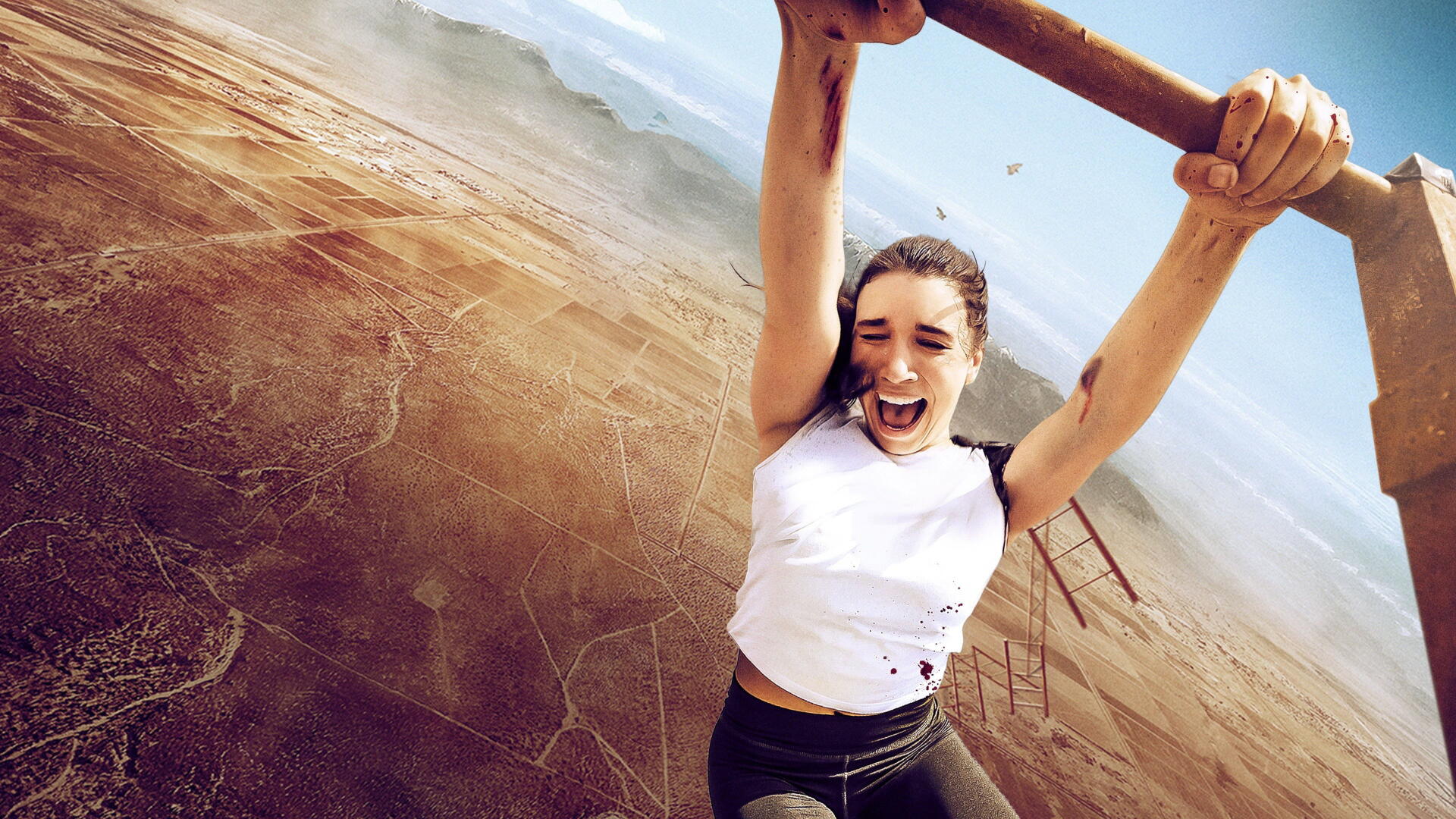 Vertigo — 4K Ultra HD PC desktop wallpaper of a woman gripping an overhead bar, dangling over a vast desert canyon with a distant bridge and wind-tousled hair.