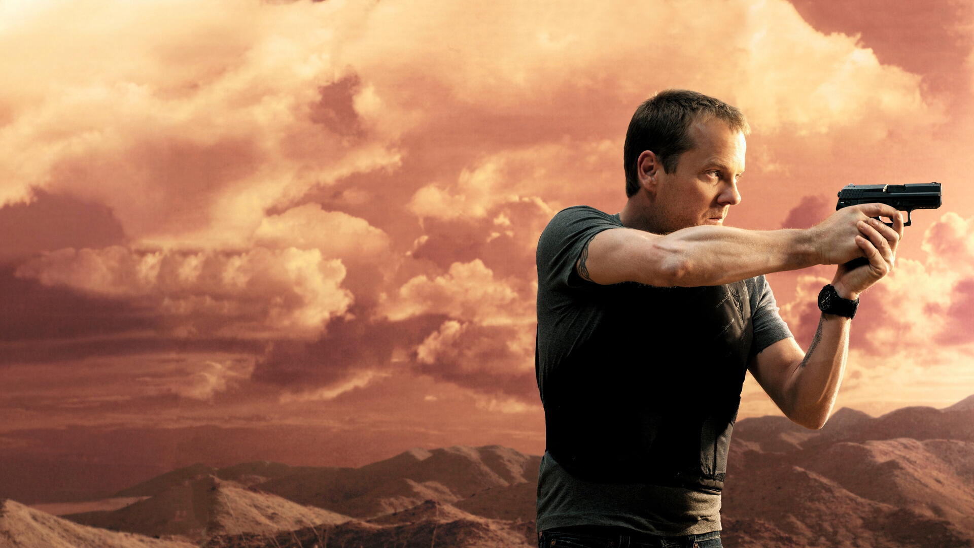 4K Ultra HD PC desktop wallpaper (tag 24): a man aiming a handgun to the right against dramatic orange clouds and a rugged mountain landscape.