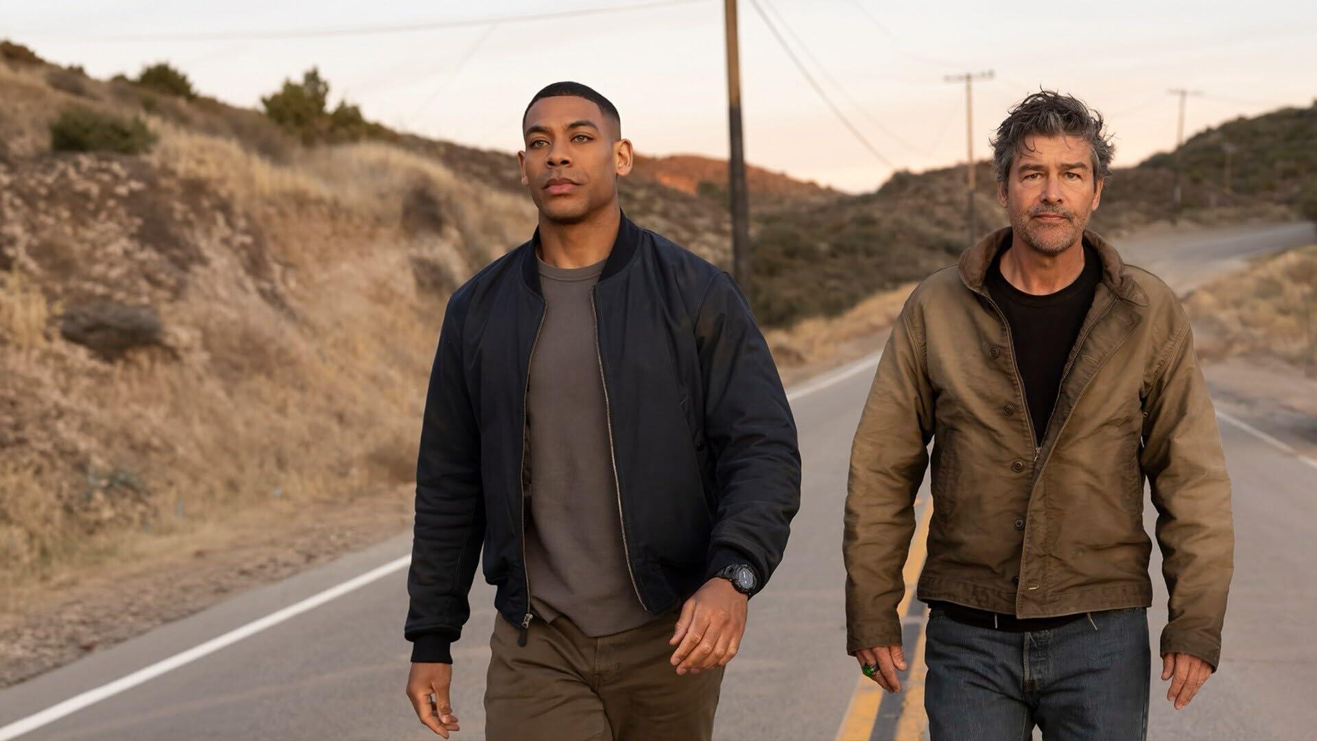 Two men walk along a desert highway at dusk in a cinematic shot from Lanterns (2026) TV show — HD PC desktop wallpaper/background.