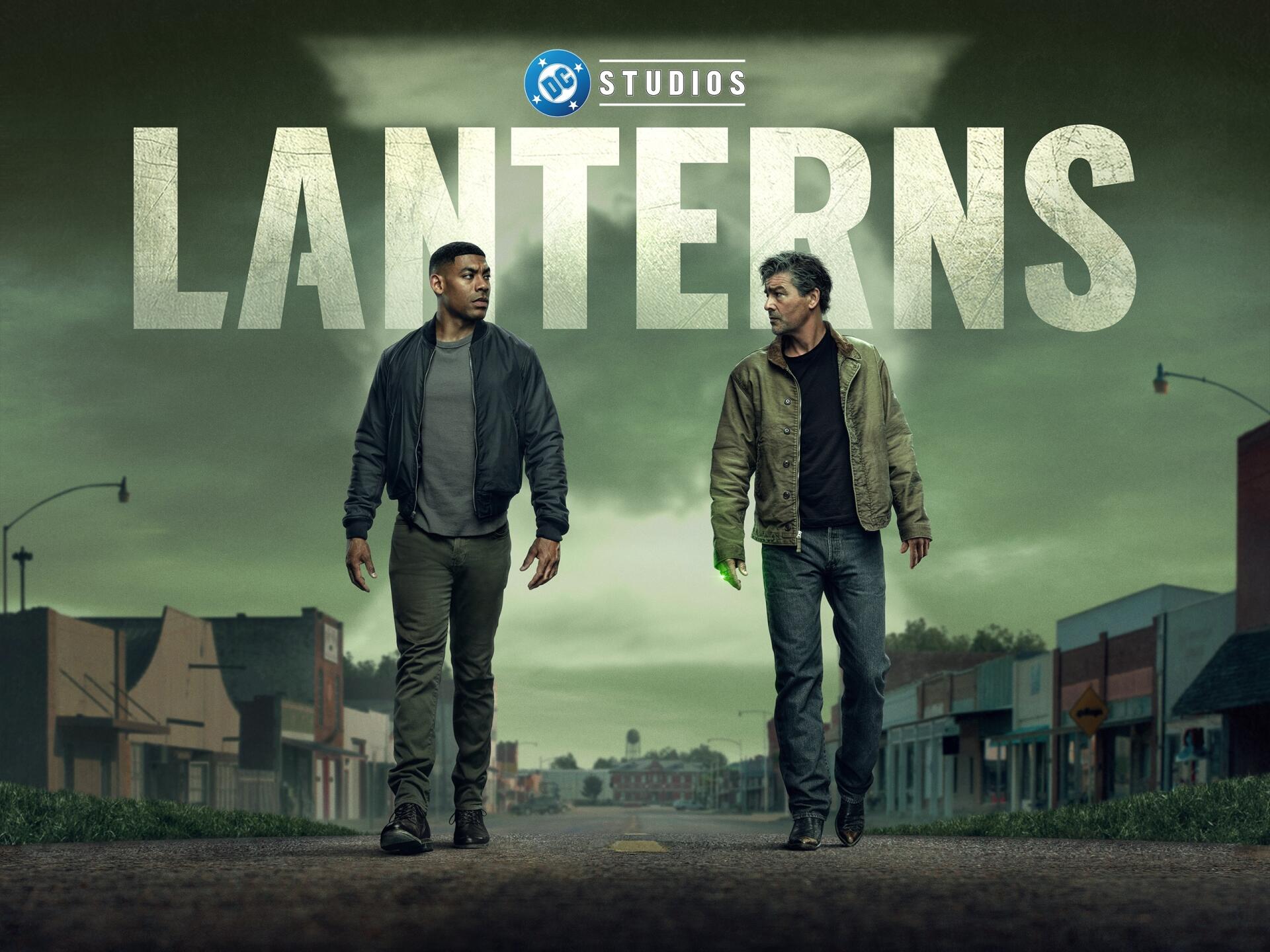Lanterns (2026) TV show 2K Quad HD PC desktop wallpaper and background: two men in jackets stride down an empty small-town street beneath a moody green sky, large LANTERNS title overhead.