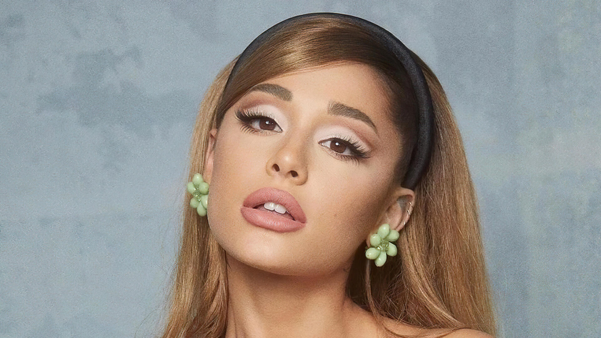 Close-up portrait of a female celebrity singer with sleek hair, bold winged eyeliner and nude lips, 4K Ultra HD PC desktop wallpaper and background.
